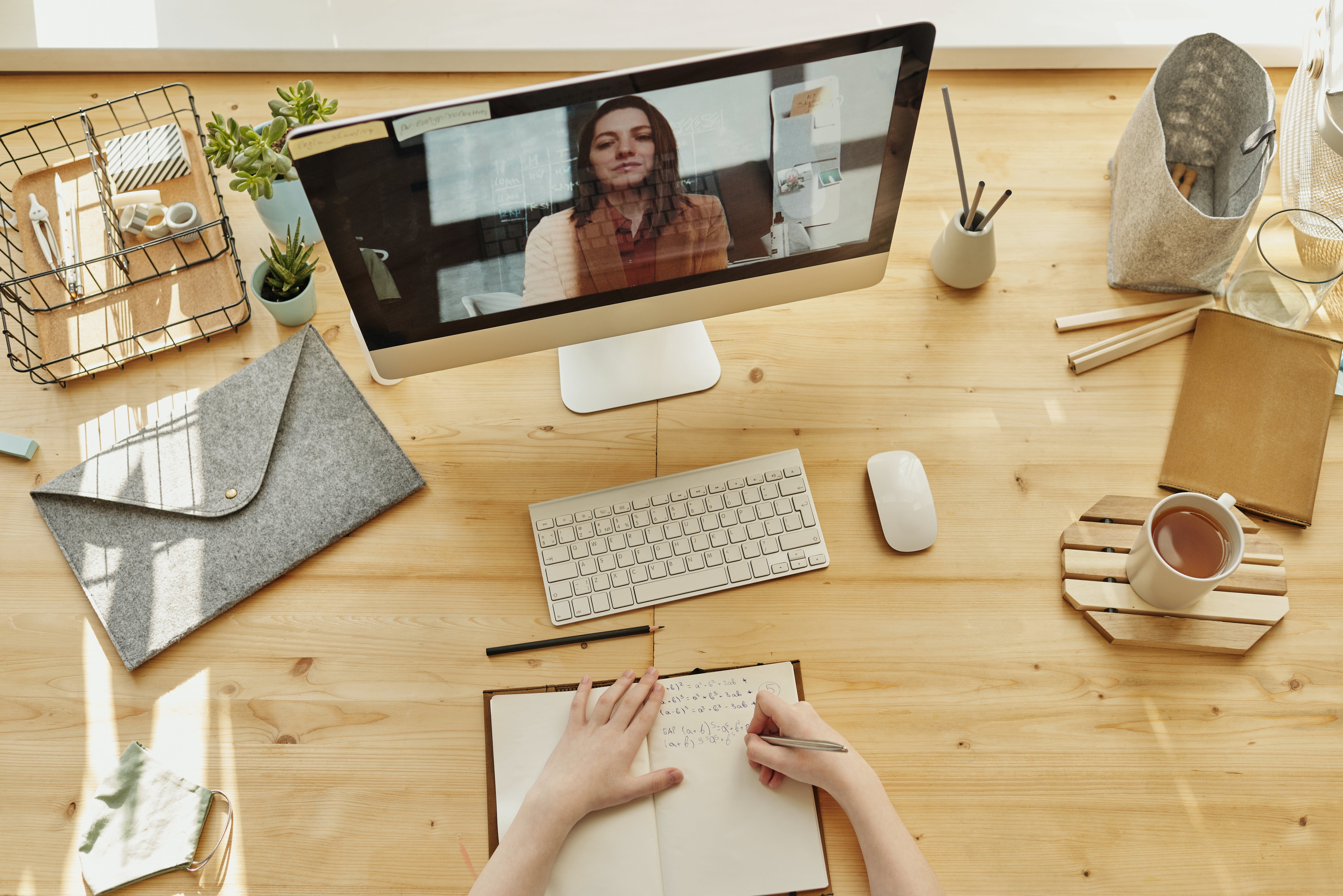 laptop on a table opened to a live meeting